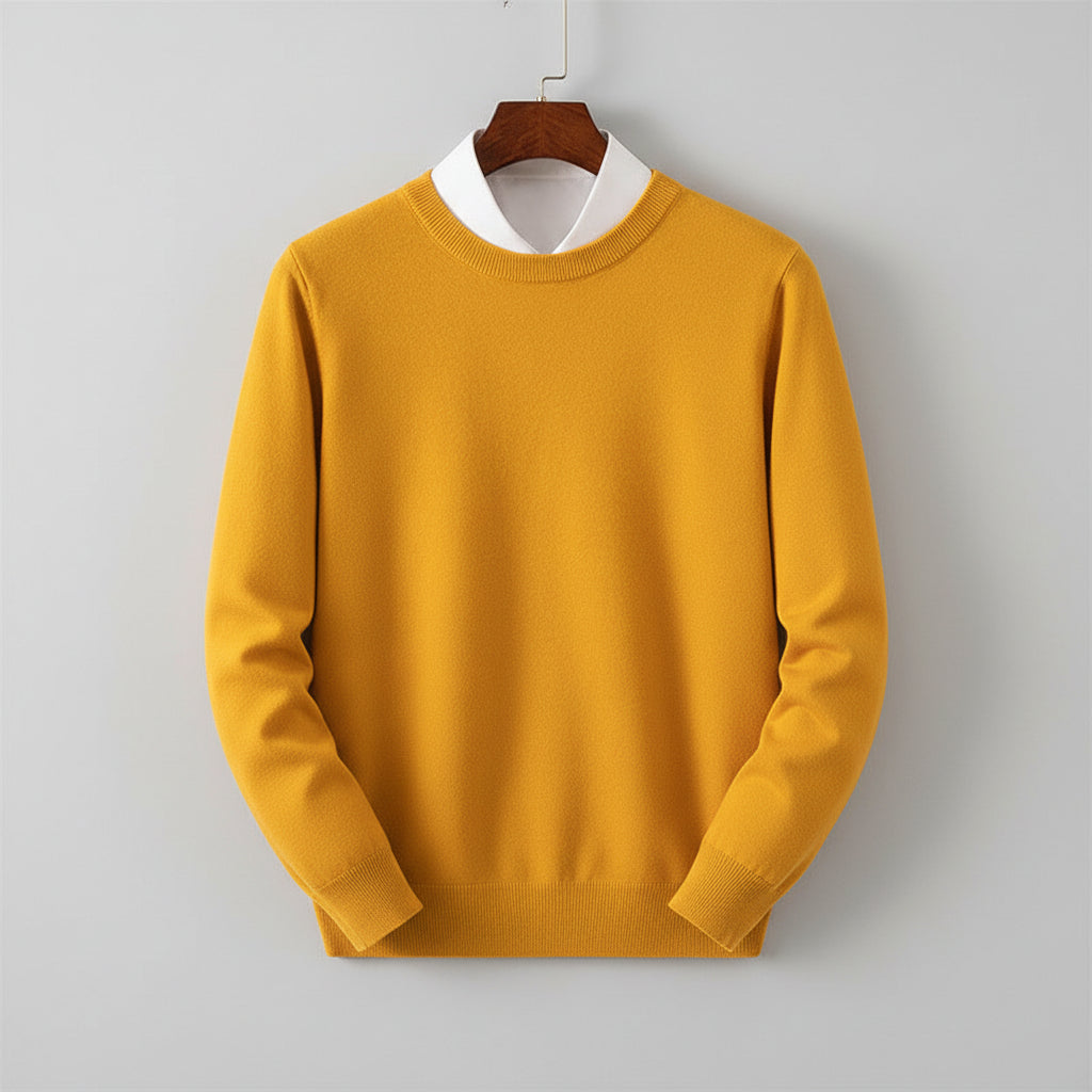 Yellow sweater on a hanger against a wooden cabinet background