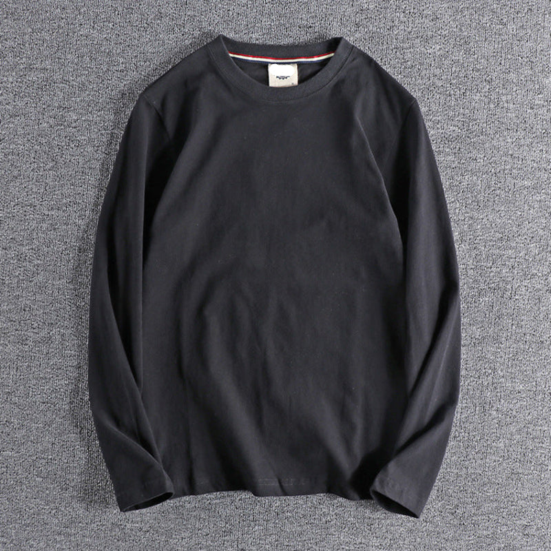 Black long-sleeve shirt on a gray background