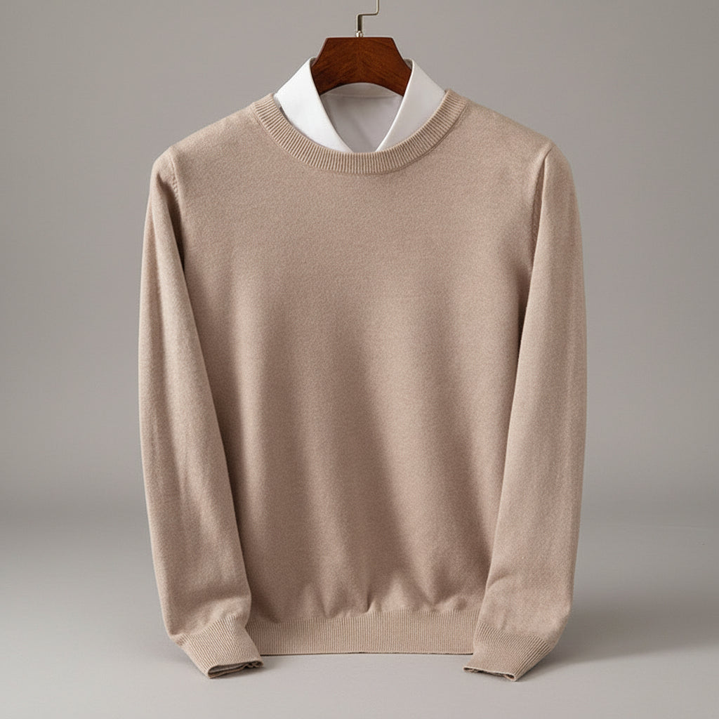 Beige sweater on a hanger against a wooden dresser background