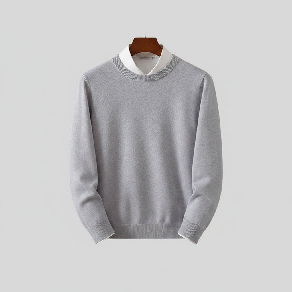 Gray sweater on a wooden hanger against a dark background