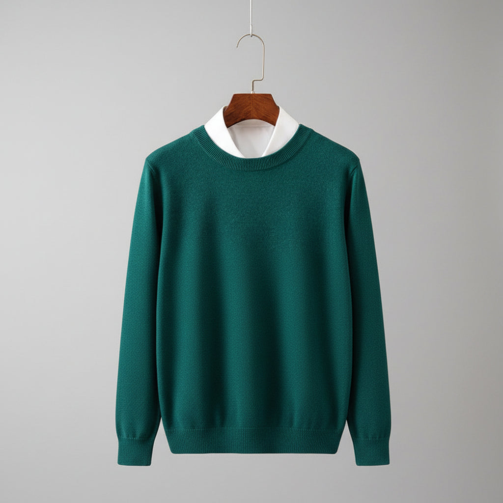 Green sweater on a wooden hanger against a dark background