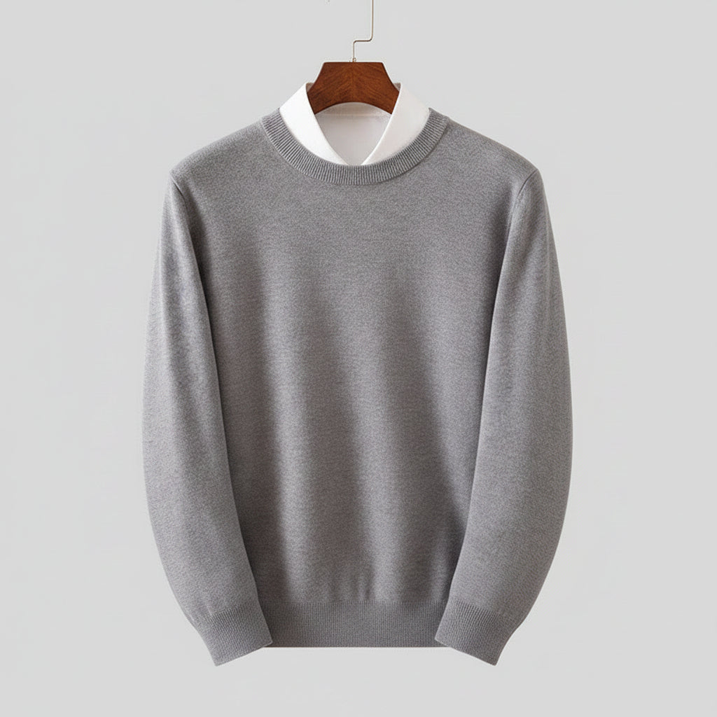Gray sweater on a wooden hanger against a dark background