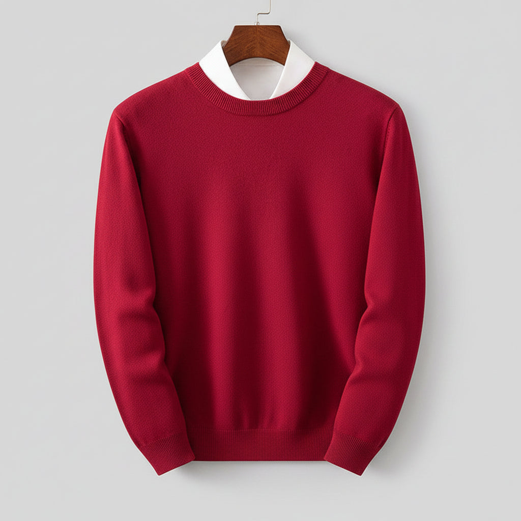 Red sweater on a hanger against a wooden dresser background