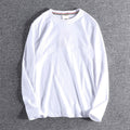 White long-sleeve shirt on a gray background
