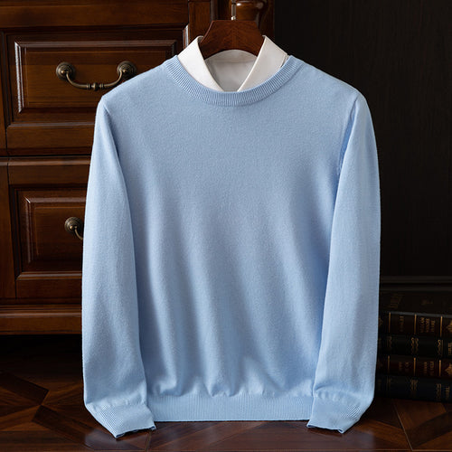 Light blue sweater on a wooden hanger against a dark wooden background