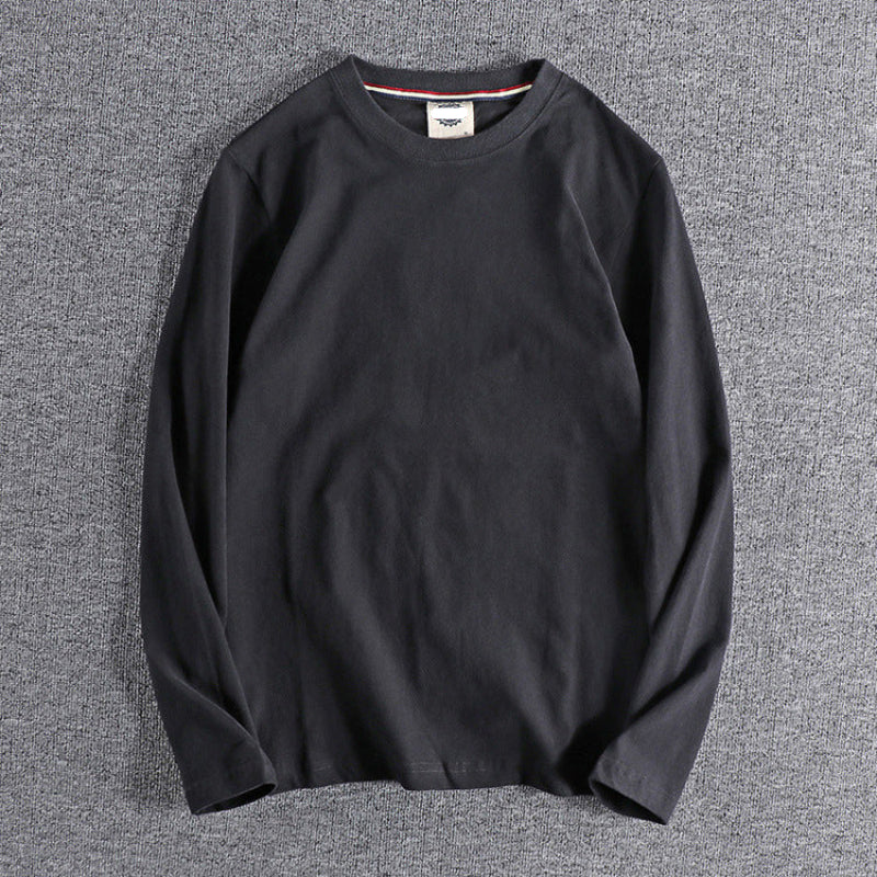 Black long-sleeve shirt on a gray background