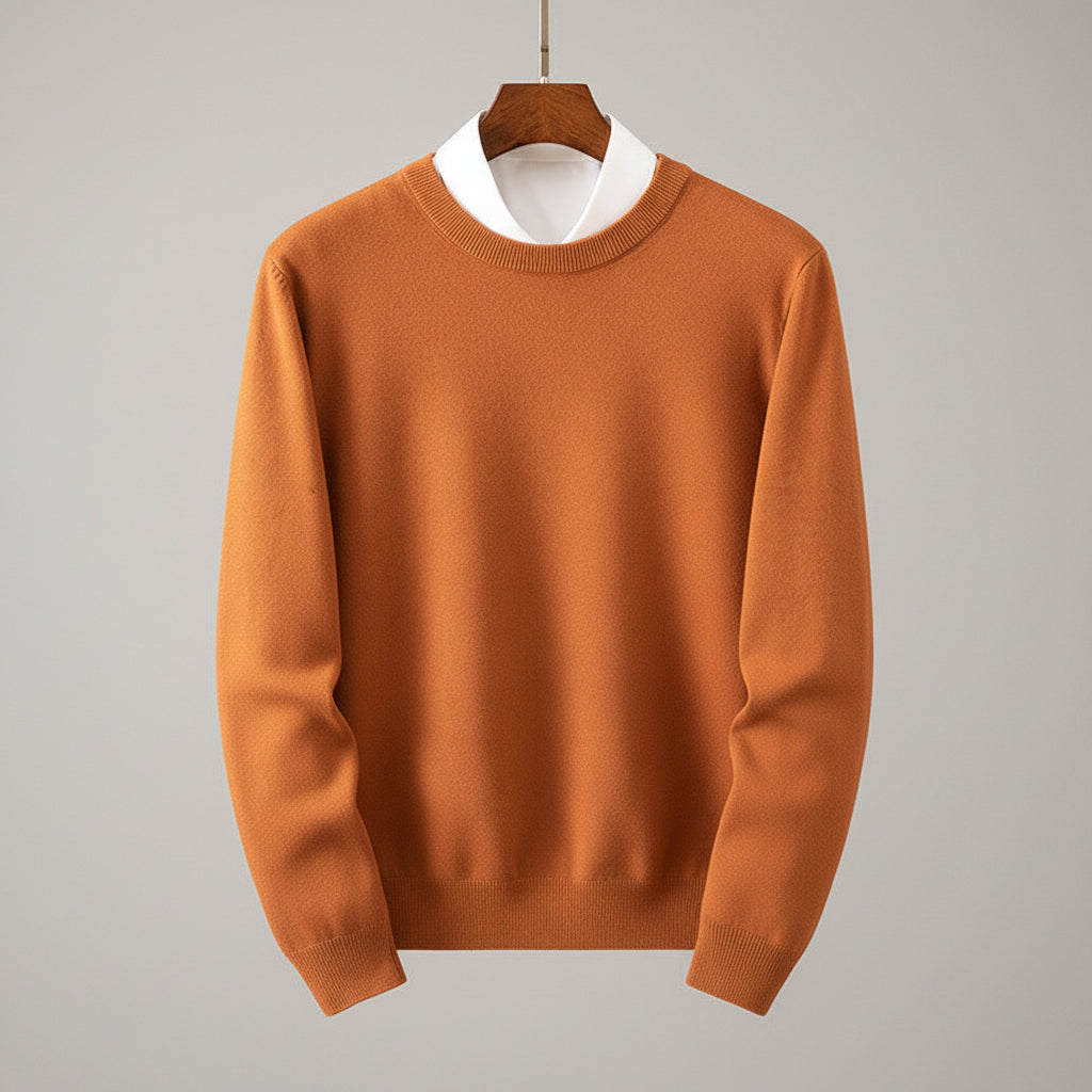 Brown sweater on a hanger against a wooden dresser background