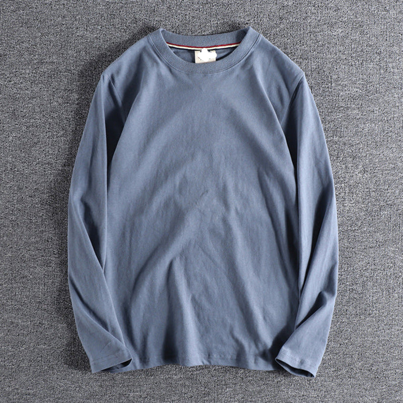 Blue long-sleeve shirt on a gray textured background