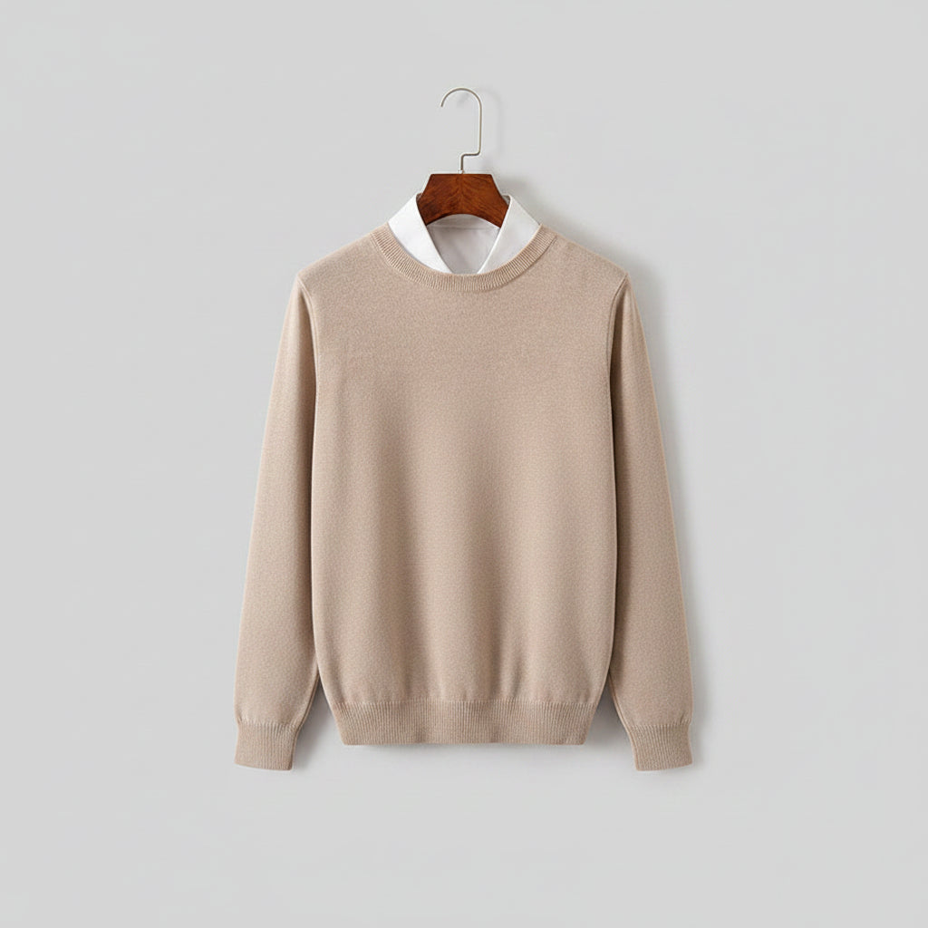 Beige sweater on a wooden hanger with a blurred background