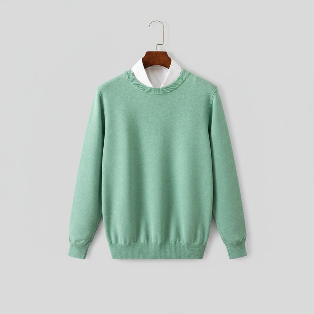 Green sweater with white shirt collar on a wooden hanger